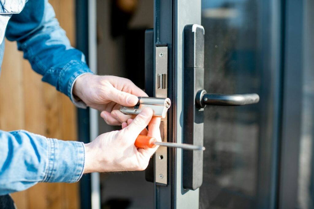 Locksmith FAQs answered by a Speed Locksmith technician changing a door lock